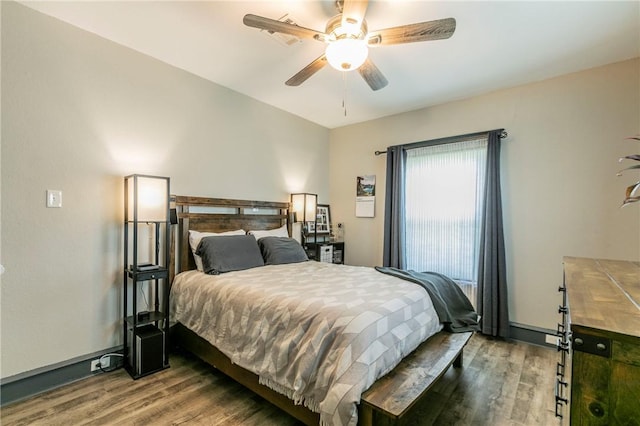 bedroom featuring ceiling fan and dark wood-type flooring