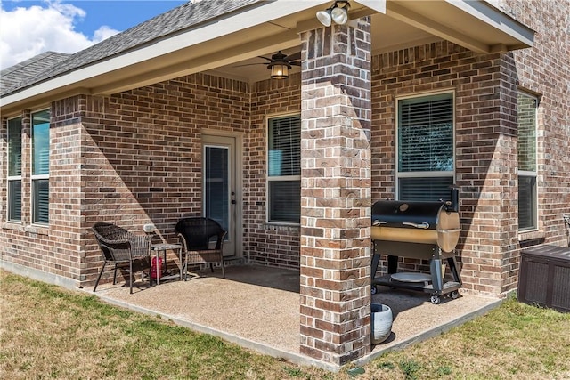 view of patio with area for grilling and ceiling fan