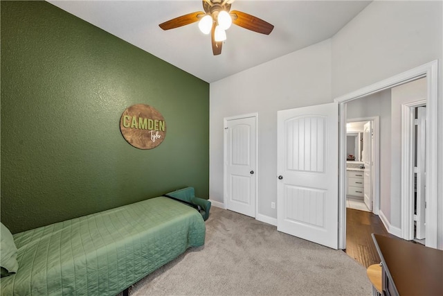 carpeted bedroom featuring a ceiling fan and baseboards