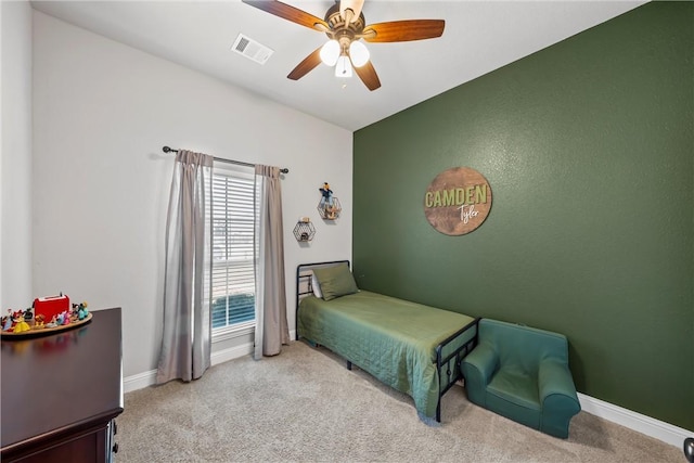 bedroom with ceiling fan, light colored carpet, visible vents, and baseboards