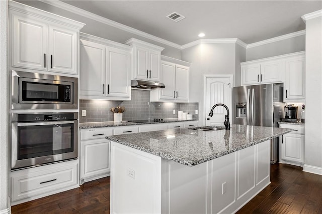 kitchen featuring dark wood-style floors, a sink, under cabinet range hood, appliances with stainless steel finishes, and white cabinetry