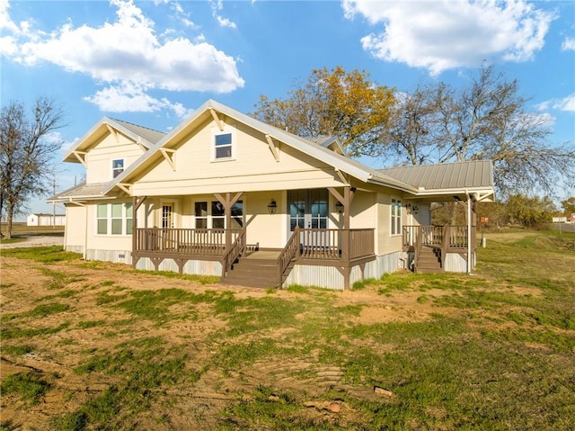 rear view of property with a porch and a lawn