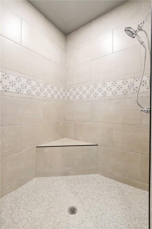 bathroom with a tile shower