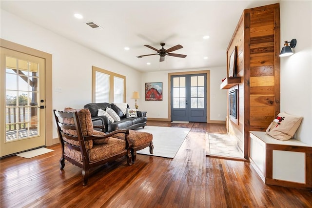 living room with hardwood / wood-style floors, french doors, and ceiling fan