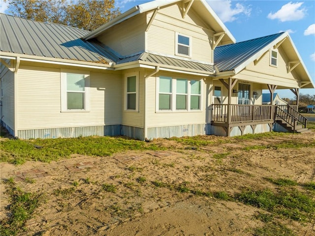 rear view of property with covered porch