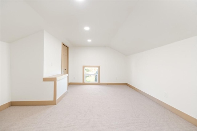 bonus room with light carpet and lofted ceiling