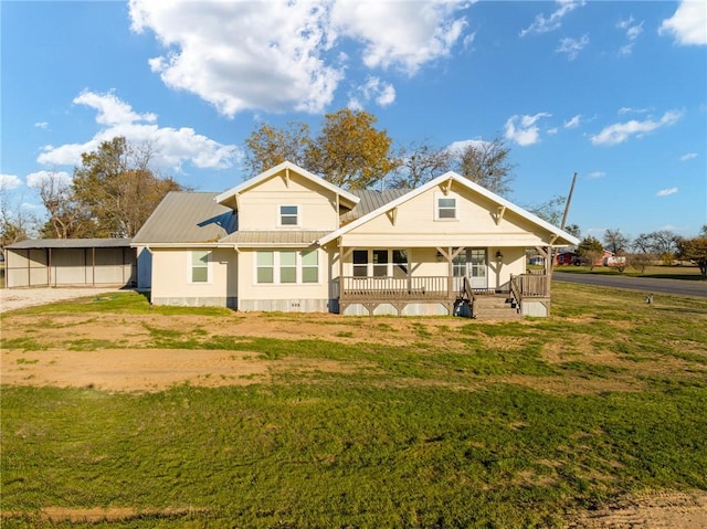 back of property featuring covered porch and a yard