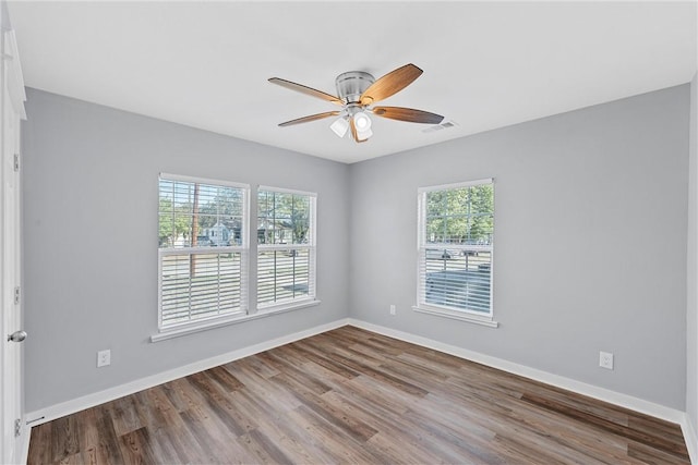 empty room with hardwood / wood-style floors and ceiling fan