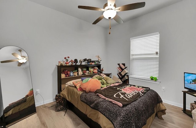 bedroom featuring ceiling fan, light wood-type flooring, and baseboards