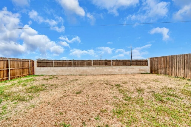 view of yard with a fenced backyard