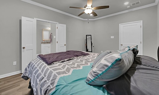 bedroom with light wood finished floors, baseboards, visible vents, a ceiling fan, and ornamental molding