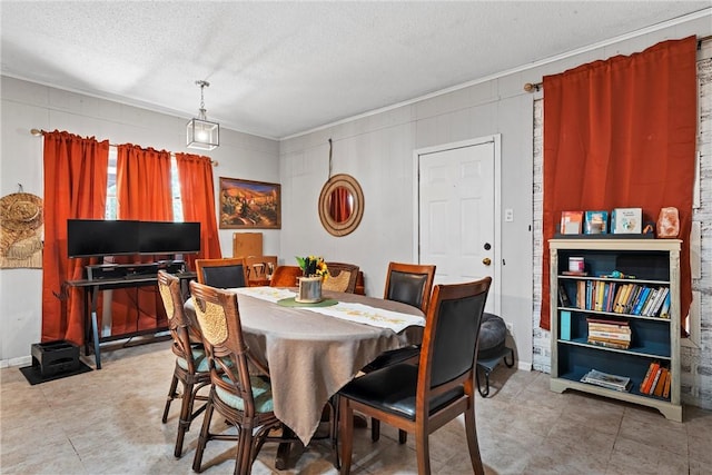 dining room featuring a textured ceiling and ornamental molding