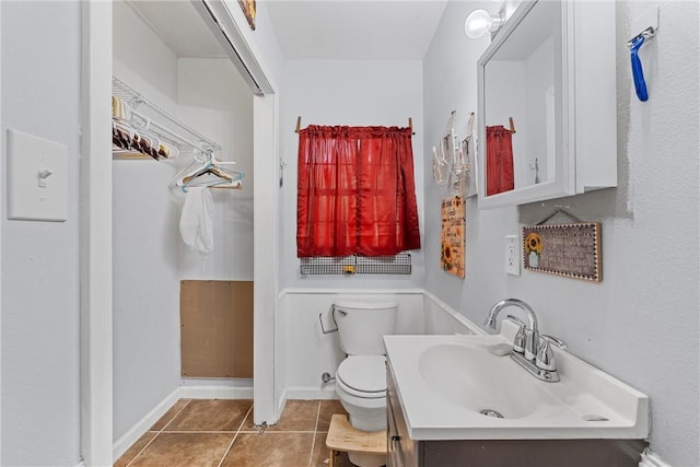 bathroom featuring tile patterned floors, vanity, and toilet