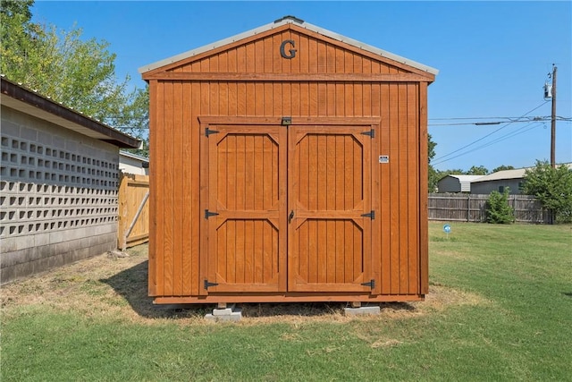 view of outdoor structure featuring a lawn