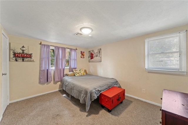 bedroom featuring carpet floors and a textured ceiling