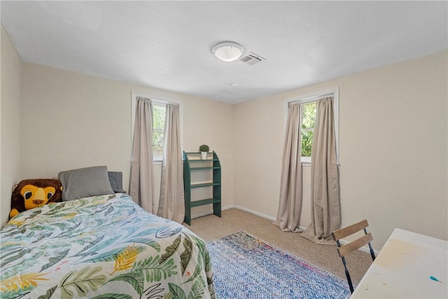 bedroom featuring light colored carpet