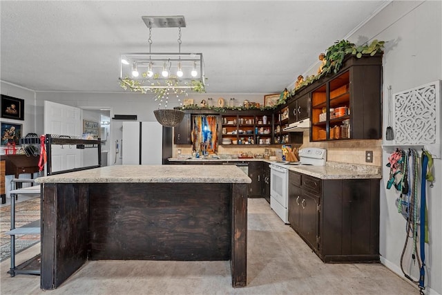 kitchen with a center island, white appliances, sink, hanging light fixtures, and dark brown cabinetry