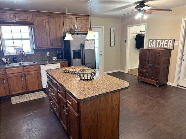 kitchen featuring dark wood-type flooring, white dishwasher, sink, stainless steel refrigerator with ice dispenser, and a kitchen island