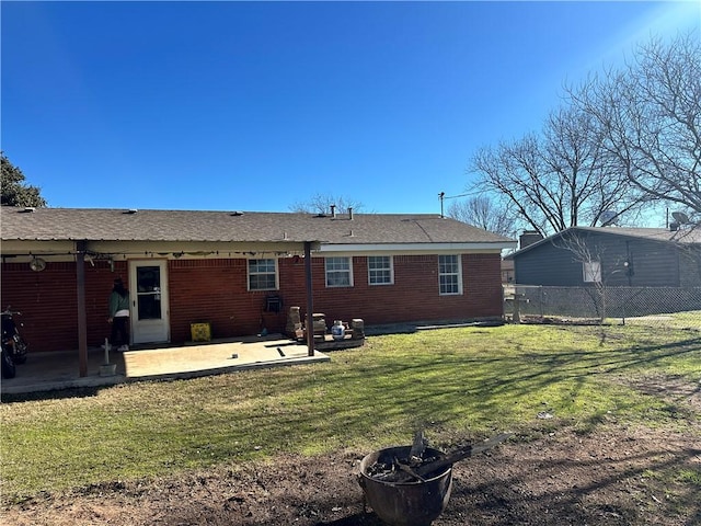 rear view of house featuring a patio and a lawn