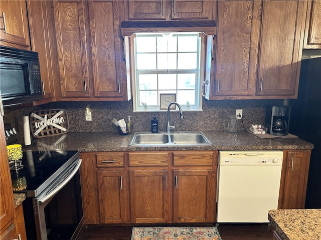 kitchen with stainless steel range with electric stovetop, white dishwasher, sink, tasteful backsplash, and stone countertops