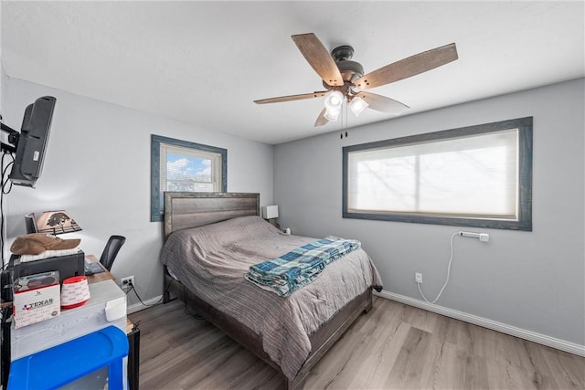 bedroom with ceiling fan and light hardwood / wood-style flooring