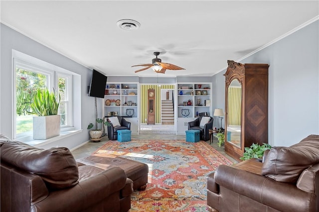 living room with built in features, ceiling fan, and crown molding