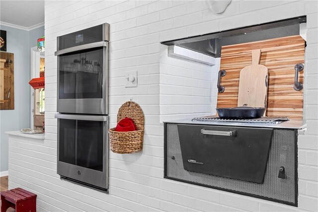 interior details with double oven and crown molding