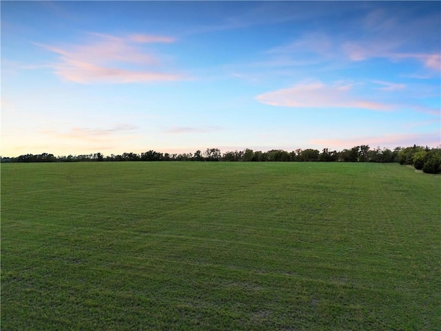 nature at dusk featuring a rural view