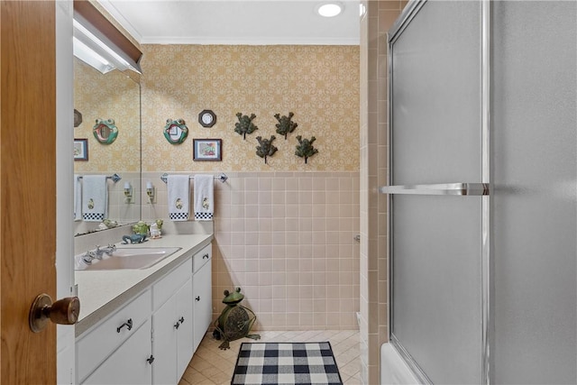 bathroom with vanity, tile walls, and ornamental molding