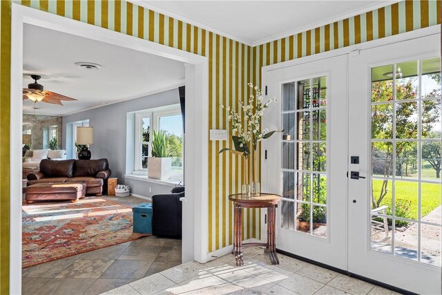 doorway with french doors, plenty of natural light, and ceiling fan