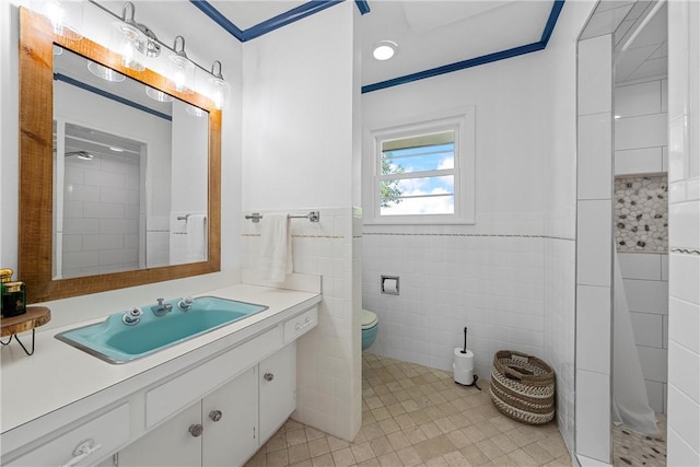 bathroom featuring vanity, a shower, tile walls, tile patterned flooring, and toilet