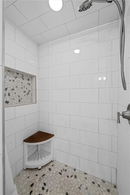 bathroom with a tile shower