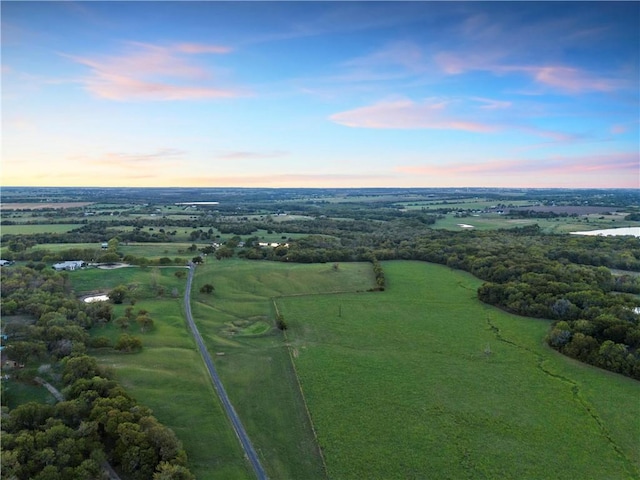 aerial view at dusk featuring a rural view