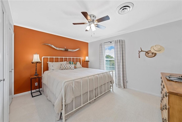 carpeted bedroom with ceiling fan and ornamental molding