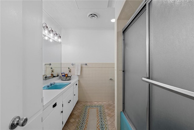 bathroom with vanity and tile walls