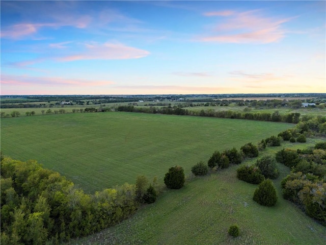 aerial view at dusk featuring a rural view