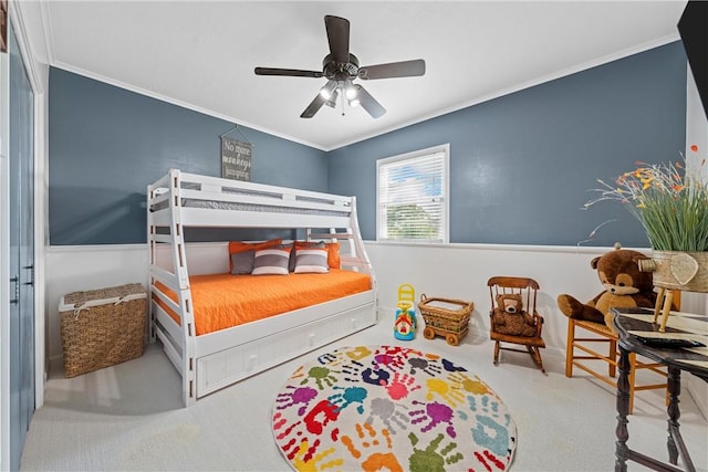 carpeted bedroom featuring ceiling fan and ornamental molding