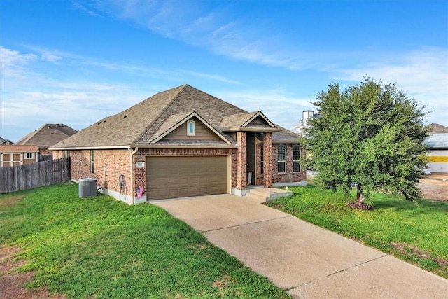 view of front of house with a front lawn, a garage, and central AC