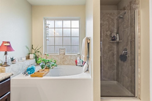 bathroom with vanity and separate shower and tub