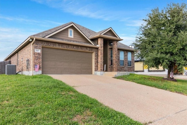 view of front of home with a garage, central air condition unit, and a front yard