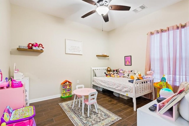 bedroom with dark hardwood / wood-style flooring and ceiling fan