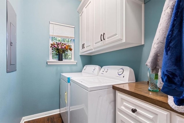 laundry area with washer and dryer, dark hardwood / wood-style flooring, cabinets, and electric panel