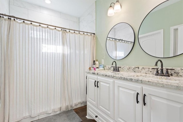 bathroom with a shower with curtain and vanity