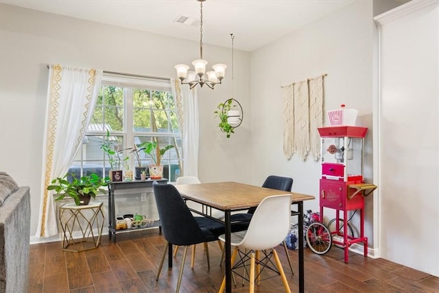 dining room featuring dark hardwood / wood-style flooring and an inviting chandelier