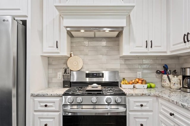 kitchen featuring decorative backsplash, appliances with stainless steel finishes, light stone counters, custom exhaust hood, and white cabinets