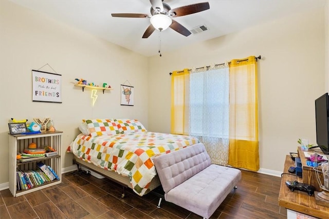 bedroom with ceiling fan and dark hardwood / wood-style floors