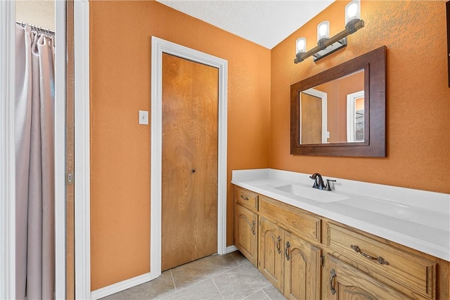 bathroom featuring tile patterned flooring and vanity