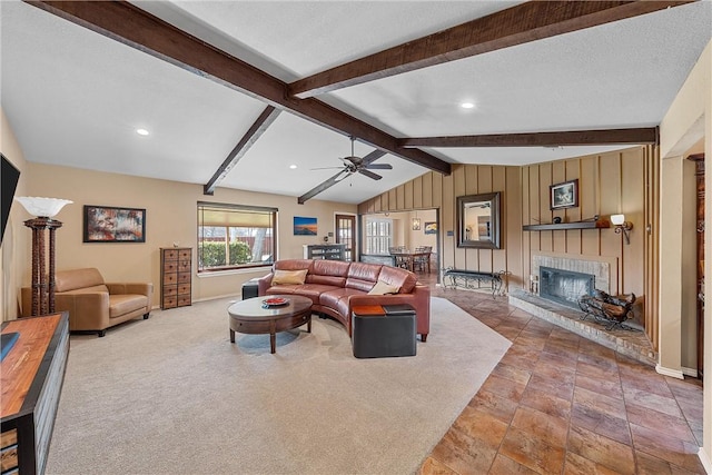 living room with lofted ceiling with beams, ceiling fan, and a textured ceiling