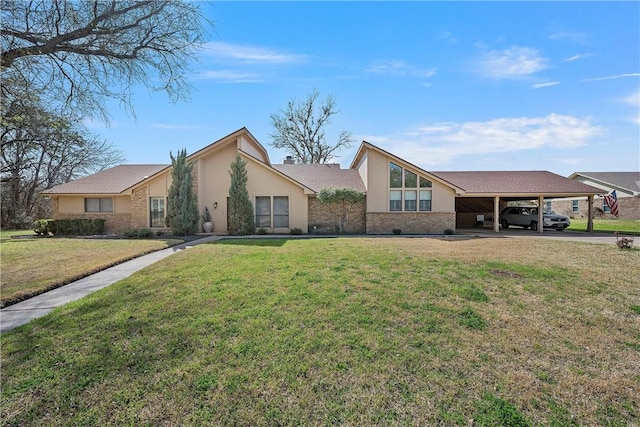 ranch-style home featuring a front lawn and a carport