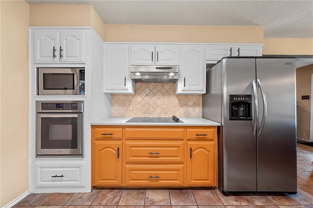 kitchen featuring tasteful backsplash, white cabinets, and appliances with stainless steel finishes